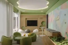 Espaço kids com poltronas verdes, TV, painel mural colorido e piscina de bolinhas — Adore Level Up em Cachoeira do Bom Jesus, Florianópolis