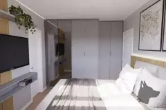Perspectiva ilustrativa do dormitório com painel de madeira, TV, guarda-roupa espelhado amplo e cama de casal — Aquamarina Residence em Cachoeira do Bom Jesus, Florianópolis