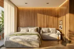 Perspectiva da suíte master com painel de madeira texturado, cama de casal, sofá e iluminação indireta quente — Art Blue View em Jurerê, Florianópolis