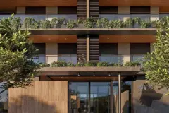 Perspectiva da fachada do Arts Home Design em close com varandas com plantas, ripas de madeira e entrada principal envidraçada — Arts Home Design em Ingleses, Florianópolis