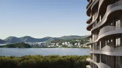 Perspectiva lateral das varandas onduladas do Aura Residence com vista para a Baía Norte e morros de Florianópolis — Aura em Agronômica, Florianópolis