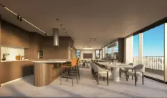 Perspectiva do salão gourmet com ilha arredondada de madeira, bancada de mármore, bancos altos, mesa oval e janelas com vista para a cidade — Aura em Agronômica, Florianópolis