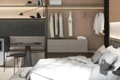 Perspectiva do quarto com closet aberto, cama de casal, mesa de trabalho e móveis modernos em madeira — Aurum Blue View em Jurerê, Florianópolis