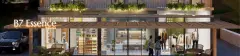 Perspectiva da fachada frontal do B7 Essence Brava à noite com térreo comercial iluminado mostrando mini mercado, cafeteria e loja de roupas — B7 Essence Brava em Praia Brava, Florianópolis