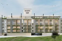 Perspectiva da fachada do B7 Essence Brava à noite com térreo comercial iluminado, varandas com vegetação e logotipos da Basseto e TACT no topo — B7 Essence Brava em Praia Brava, Florianópolis