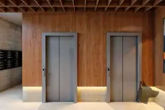 Perspectiva do lobby de elevadores do B7 Essence Brava com dois elevadores embutidos em painel de madeira e caixas de correio — B7 Essence Brava em Praia Brava, Florianópolis