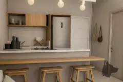 Perspectiva da cozinha americana do apartamento compacto do B7 Essence Brava com bancada, banquetas de madeira e prateleiras abertas — B7 Essence Brava em Praia Brava, Florianópolis
