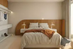 Perspectiva do quarto master do apartamento do B7 Essence Brava com cama de casal, cabeceira em madeira curva e closet aberto ao fundo — B7 Essence Brava em Praia Brava, Florianópolis