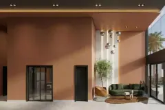 Perspectiva do lobby do B7 Park Marina, vista frontal com sofá verde, árvore e pendentes metálicos — B7 Park Marina em Agronômica, Florianópolis