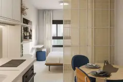Studio com cozinha americana, mesa de jantar redonda e dormitório separado por divisória em rattan — Bella Sintra Residence em Estreito, Florianópolis