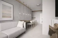Sala de estar com sofá branco, mesa de jantar comprida com pendentes e parede de cimento queimado — Bella Sintra Residence em Estreito, Florianópolis