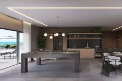 Salão de jogos com mesa de sinuca, balcão bar, adega e acesso à piscina ao fundo — Bellomonte Residence em Ingleses, Florianópolis