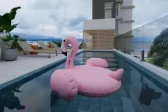 Piscina no rooftop com boia de flamingo rosa, espreguiçadeiras e vista para a Baía Norte — Beriyth Residence em Cachoeira do Bom Jesus, Florianópolis