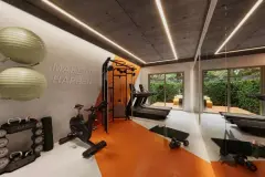 Academia com piso laranja, aparelhos de musculação, bike ergométrica e parede com frase Make it Happen — BG Connect Canas em Canasvieiras, Florianópolis