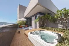 Cobertura com jacuzzi embutida em deck de madeira, mesa bistrô, guarda-sol e frangipani — BG Connect Trindade 2 em Trindade, Florianópolis