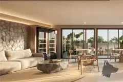 Lounge do Brizz Smart Stay com sofá, mesa de pedra, parede de pedra rústica e varanda com jardim ao fundo — Brizz Smart Stay em Cachoeira do Bom Jesus, Florianópolis