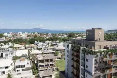 Vista aérea do Brizz Smart Stay com bairro de Cachoeira e o mar da Baía Norte ao pôr do sol — Brizz Smart Stay em Cachoeira do Bom Jesus, Florianópolis