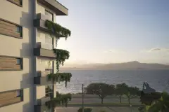 Perspectiva da fachada lateral do Domus 544 com sacadas com plantas e baía ao fundo, ângulo alternativo — Domus 544 em Agronômica, Florianópolis