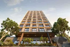 Fachada diurna do edifício Easy Studios com revestimento em grade dourada, jardins e entrada principal — Easy Studios em Centro, Florianópolis