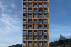 Fachada frontal do edifício Easy Studios ao entardecer com janelas em grade dourada e Morro da Cruz ao fundo — Easy Studios em Centro, Florianópolis