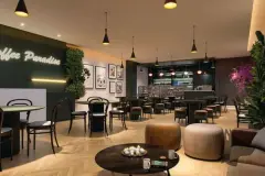 Perspectiva do coffee shop Coffee Paradise do Essência Carlessi com mesas, bar e prateleiras iluminadas — Essência Carlessi em Córrego Grande, Florianópolis