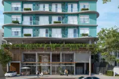 Fachada frontal do edifício com lojas no térreo, varandas com vegetação e arquitetura contemporânea em verde-água — Gaivotas 4 em Ingleses, Florianópolis