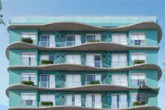 Fachada superior do edifício com varandas onduladas em concreto, revestimento verde-água e pastilhas teal — Gaivotas 4 em Ingleses, Florianópolis