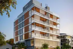 Fachada do edifício com revestimento em madeira e pedra, varandas envidraçadas e logotipo Gáico no topo — Galleria 50 em Jurerê, Florianópolis