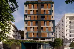 Fachada frontal do edifício com venezianas amadeiradas, jardins verticais e entrada principal envidraçada — HUB Beira Mar em Saco dos Limões, Florianópolis