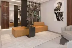 Render do hall do térreo com sofás laranja, sinalização de circulação e jardim suspenso — Imob Canas em Canasvieiras, Florianópolis