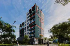 Fachada do edifício à luz do dia, torre alta com varandas destacadas em verde e vermelho — Imob Trindade On em Trindade, Florianópolis