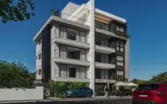 Fachada diagonal compacta do edifício de 5 andares com varandas e área de convivência — Imperial Residence em Campeche, Florianópolis