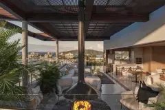 Rooftop com sofás, lareira suspensa cônica, pergolado de madeira e vista panorâmica para o bairro e o mar — Infinite Campeche em Campeche, Florianópolis