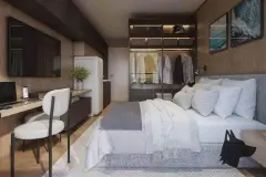 Cozinha americana integrada à sala com bancada de mármore, banquetas, coifa cilíndrica e sofá ao fundo — Infinite Campeche em Campeche, Florianópolis
