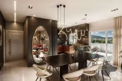Sala de jantar e cozinha integradas com mesa escura, espelho oval, lustre design e bancada de cobre — Infinity Residence em Ingleses, Florianópolis