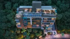 Perspectiva aérea do Liv 2460 Boutique Residence à noite com rooftop iluminado e vegetação ao redor — LIV 2460 Boutique Residence em João Paulo, Florianópolis