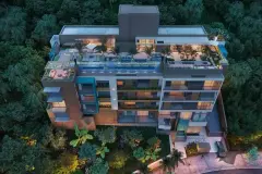 Perspectiva aérea do Liv 2460 Boutique Residence ao entardecer com rooftop iluminado e vegetação — ângulo alternativo — LIV 2460 Boutique Residence em João Paulo, Florianópolis