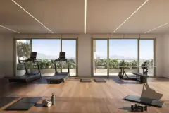 Perspectiva ilustrativa da academia com esteiras, equipamentos de musculação e grandes janelas com vista para a cidade e montanhas — Lumina Residence em Cachoeira do Bom Jesus, Florianópolis