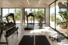 Academia com equipamentos de musculação e janelas amplas com vista para área verde — Lunáh Blue View em Campeche, Florianópolis