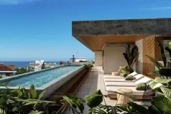 Terraço com piscina raia, espreguiçadeiras, plantas tropicais e vista para o mar — Lunáh Blue View em Campeche, Florianópolis
