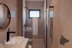 Banheiro com box de vidro, cuba branca, gabinete amadeirado e espelho redondo — Mar do Norte Studios em Ingleses, Florianópolis