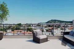 Terraço com espreguiçadeiras de vime e vista panorâmica para a cidade e os morros — Mar do Norte Studios em Ingleses, Florianópolis
