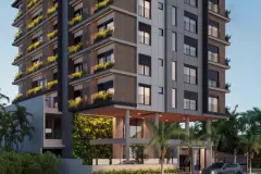 Fachada do edifício ao entardecer com revestimento amadeirado e vegetação nos balcões — Mar do Norte Studios em Ingleses, Florianópolis
