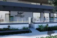 Térreo do empreendimento com letreiro Maranello Residence, jardim e vitrine de imobiliária ao fundo — Maranello Residence em Balneário, Florianópolis
