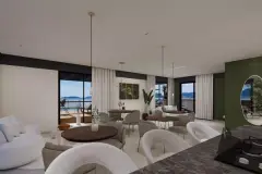 Espaço gourmet amplo com poltronas e mesas redondas, decoração sofisticada e varanda com vista para a Baía Norte — Maranello Residence em Balneário, Florianópolis
