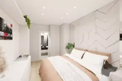 Suíte com cama de casal, cabeceira estofada com painel geométrico e acesso à varanda — Maranello Residence em Balneário, Florianópolis