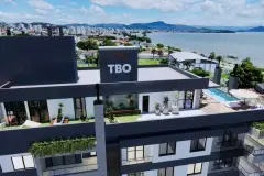 Terraço intermediário com playground colorido, jardim gramado e academia ao fundo com vista para a Baía Norte — Maranello Residence em Balneário, Florianópolis