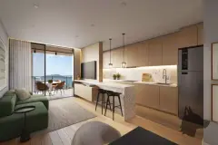 Sala de estar com sofá verde, cozinha integrada com ilha em pedra e varanda com vista para o mar — Marena em Canasvieiras, Florianópolis