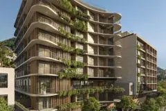 Fachada lateral diurna com varandas curvas cobertas de vegetação, pilares e área verde no térreo — Max Studios 177 em Pantanal, Florianópolis