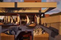Terraço gourmet ao entardecer com sofás de rattan e poltronas suspensas, ângulo alternativo — Maxxi Garden em Cachoeira do Bom Jesus, Florianópolis